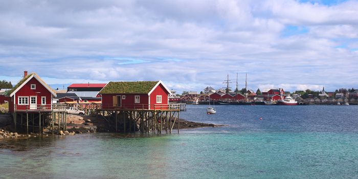 Typical red wooden fisherman's cabins called Rorbu built on stilts in the small town called Reine on Moskenesoya, Lofoten, Norway