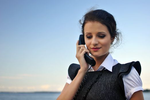 girl with a telephone receiver in hand, space for text