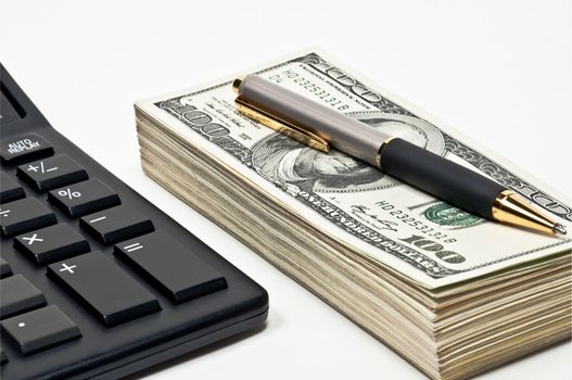 Business concept, bundle of money, pen and calculator.