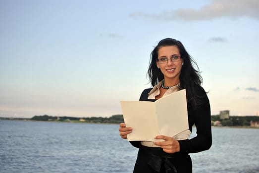 girl holding blank paper. sea on the background