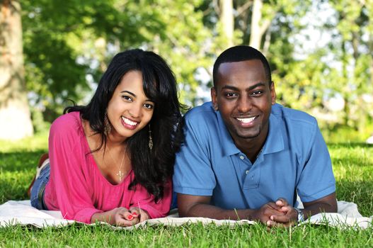 Young romantic couple enjoying summer day in park