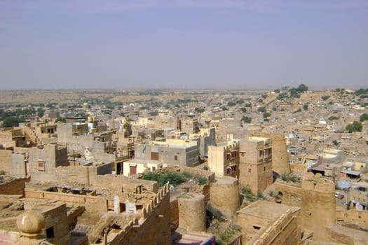 An Indian in Rajasthan state, with ancient architecture.