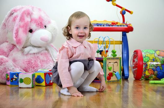 little girl in a room with toys