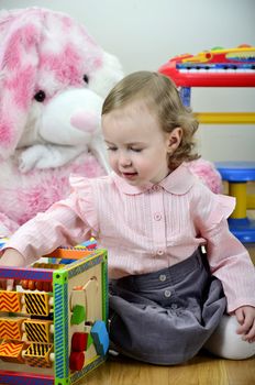 little girl in a room with toys