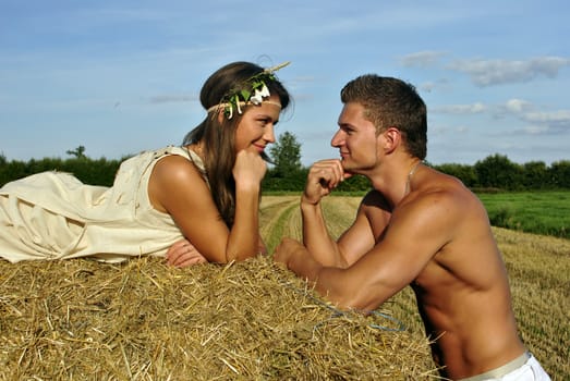 bodybuilder with a cute girl in the countryside