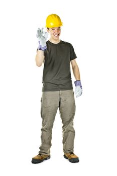 Smiling construction worker showing okay sign standing isolated on white background