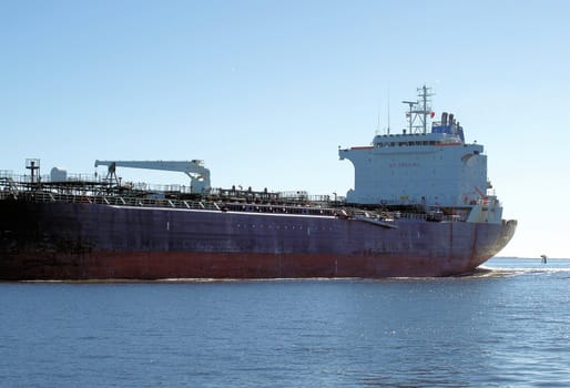 Cargo ship in the water riding high after dropping off it's load.