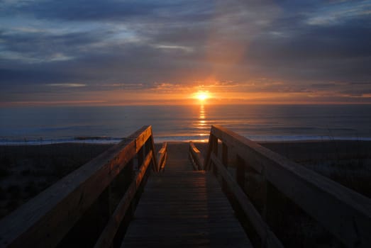 Sun over the ocean in North Carolina as seen from the boardwalk to the beach.