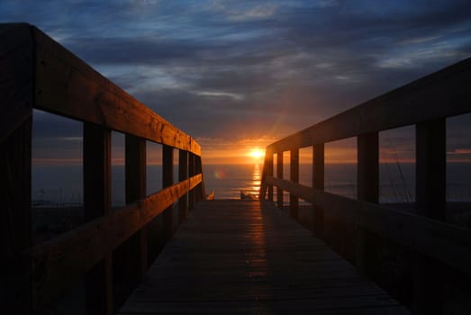 Sun over the ocean in North Carolina as seen from the boardwalk to the beach.