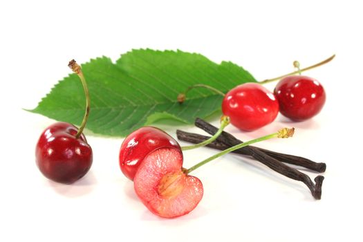 fresh cherries with vanilla on white background