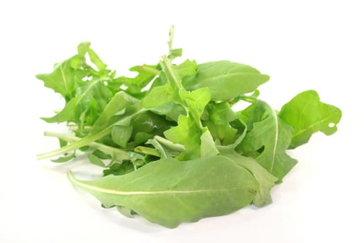 a pile of rocket leaves on a white background