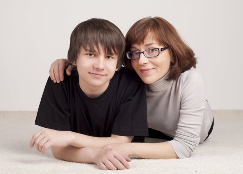 mother and son are together and smile in studio