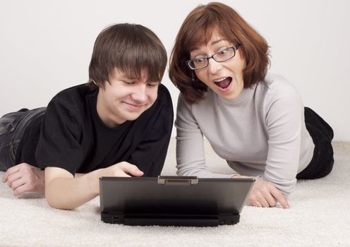 mother and son are together, work with notebook