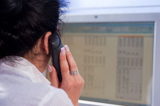 Secretary on the telephone in front of her computer