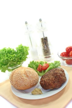 meatball with bun, fresh lettuce and tomato pieces