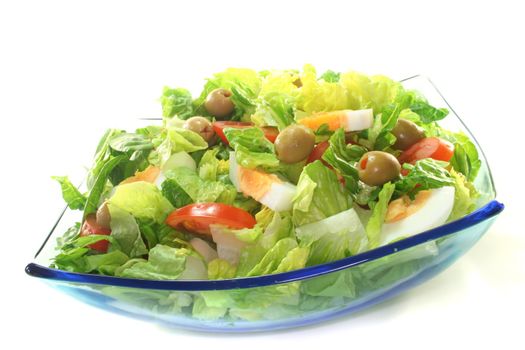 Mixed salad with egg, tomatoes, olives and salad leaves