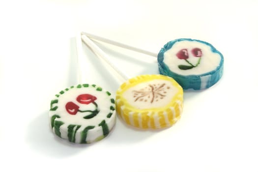 three colorful lollipops on a white background