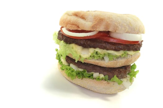 double hamburger with fresh vegetables on white background