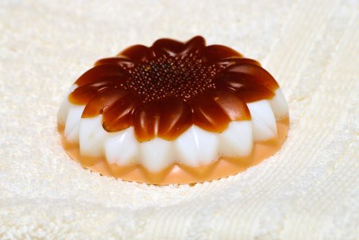 Natural Handmade Sunflower-Shaped Soap on a white towel.