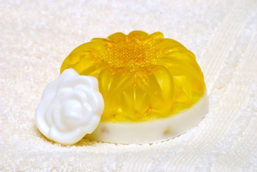 Natural Handmade Sunflower-Shaped Soap on a white towel.