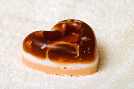 Natural Handmade Heart-Shaped Soap on a white towel.