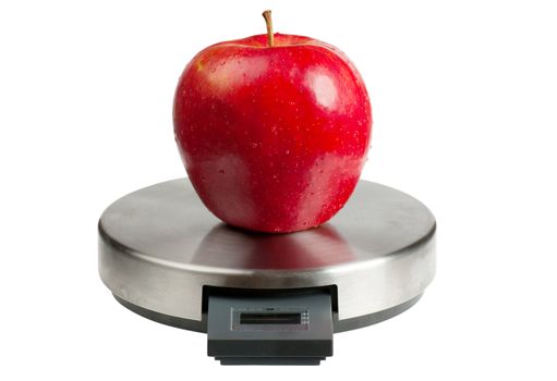Big red apple on a scales isolated over white background. Diet concept