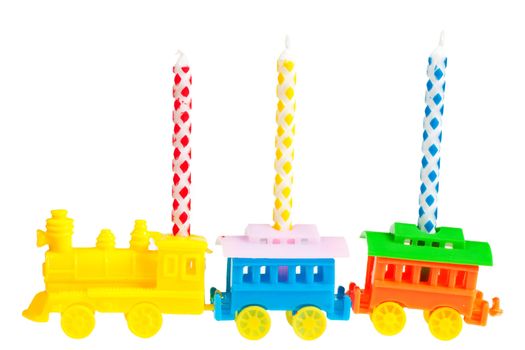 Macro view of three birthday candles in a train-shaped support