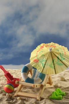 Deck chair with umbrella, water polo and swimming ring on the beach