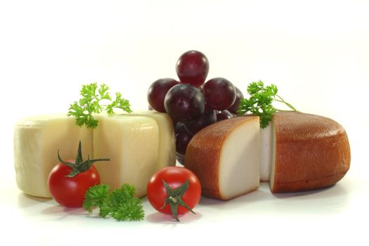 various Cheese with fresh tomatoes, grapes and parsley