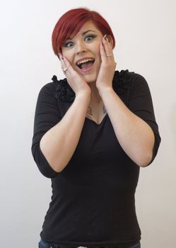 Portrait of a girl with red hair, piercing on lower lip, and tattoos on chest and shoulders, surprise  expression