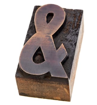 ampersand symbol  - a vintage wood letterpress type block, stained by black ink, isolated on white