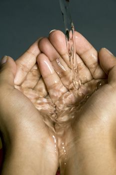 Hands collecting water