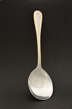 silver spoon on a black