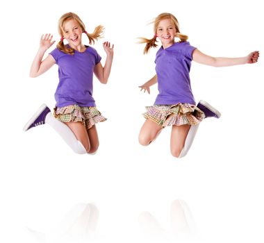Happy teenager girls identical twins jumping and laughing of happiness having fun, isolated.
