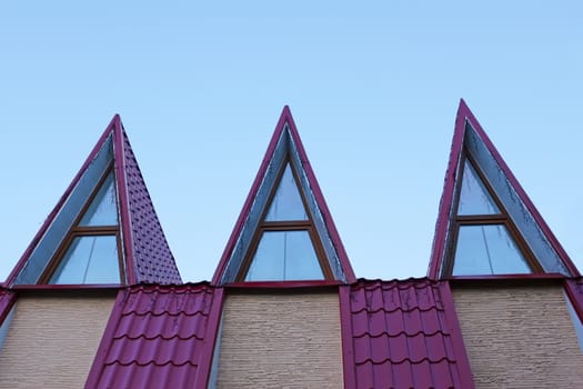Detail of the roof covered with metal tile in evening light
