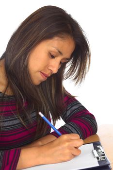 Young Peruvian woman writing with a pencil on white paper (Selective Focus, Focus on the eye) 
