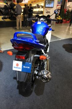 Looking at Suzuki new motorcycles during EICMA 2011, International Motorcycle Exhibition.