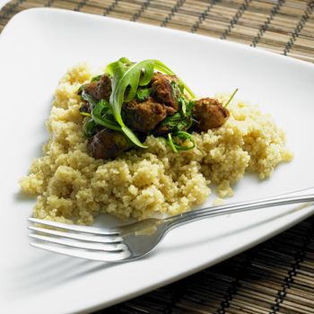 chicken meat with rucola on couscous