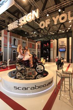 Looking at new Scarabeo motorcycles during EICMA 2011, International Motorcycle Exhibition.