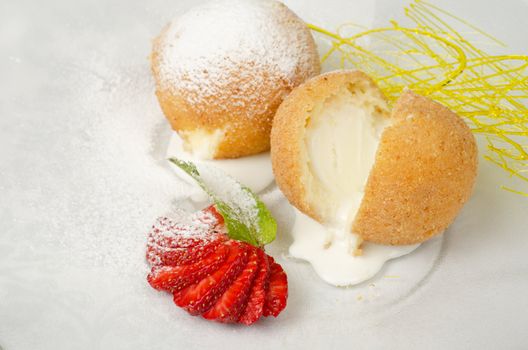 Dessert of ice-cream at biscuit with strawberry and caramel