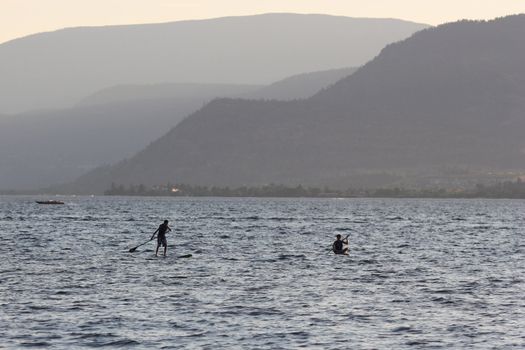 two silhouettes on water