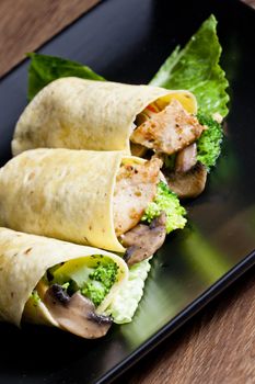 tortilla filled with chicken meat and vegetables