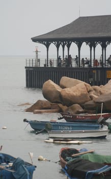 Boathouse and small boats in the harbor of Hong Kong