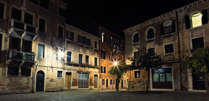 Little place with paving stone in Venice by night
