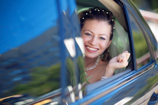 portrait of the bride in the car