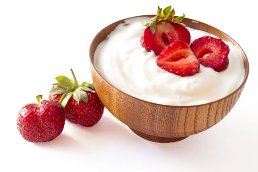 strawberry and yogurt  in a wooden bowl on withe background