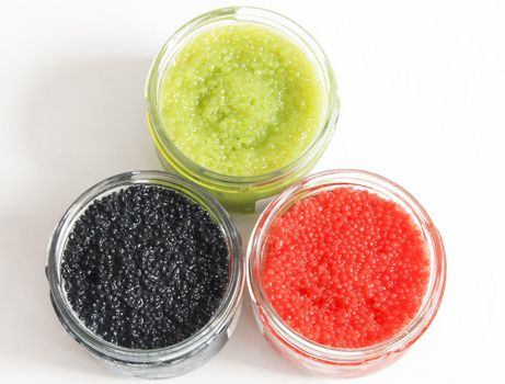 the red, green and black caviar in glass jars on withe background