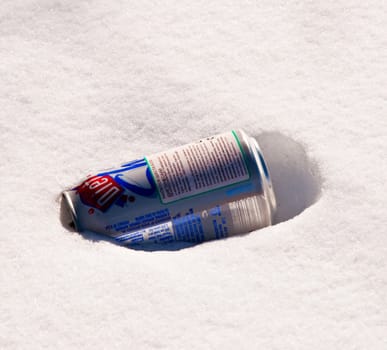 Bank iron from under a drink laying on snow