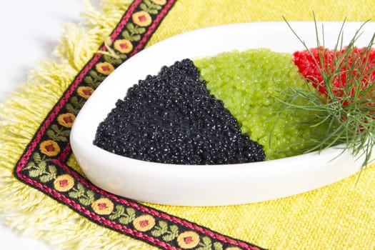 caviar in a bowl-shaped over on  yellow background