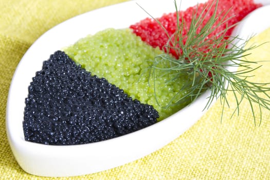 caviar in a bowl-shaped over on  yellow background